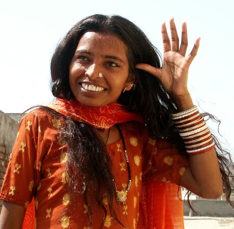 Smiling woman in orange clothing in Punjab